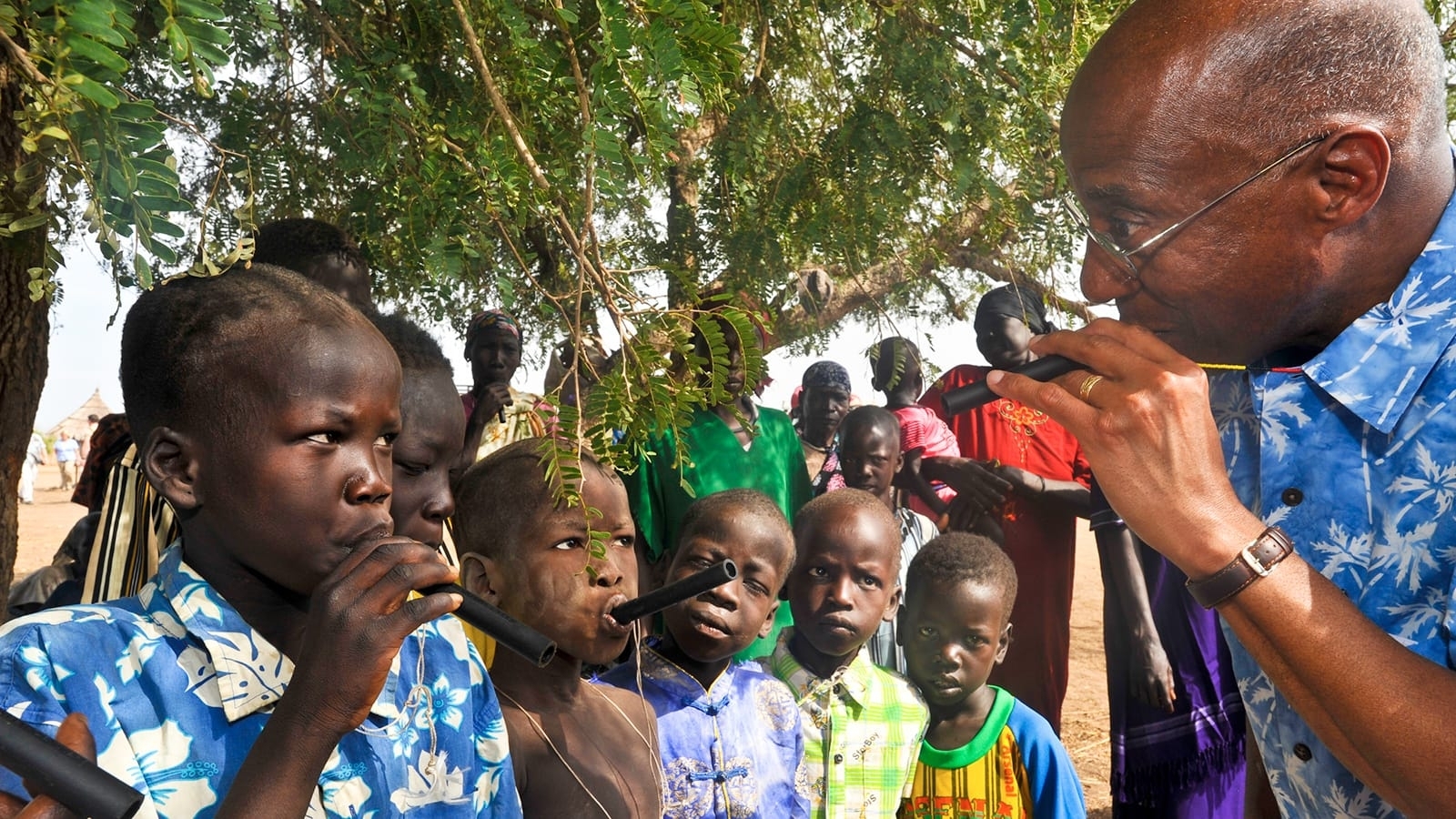 Dr. Donald R. Hopkins shows children in Terekeka County, South Sudan, how to use a portable pipe filter to prevent Guinea worm disease