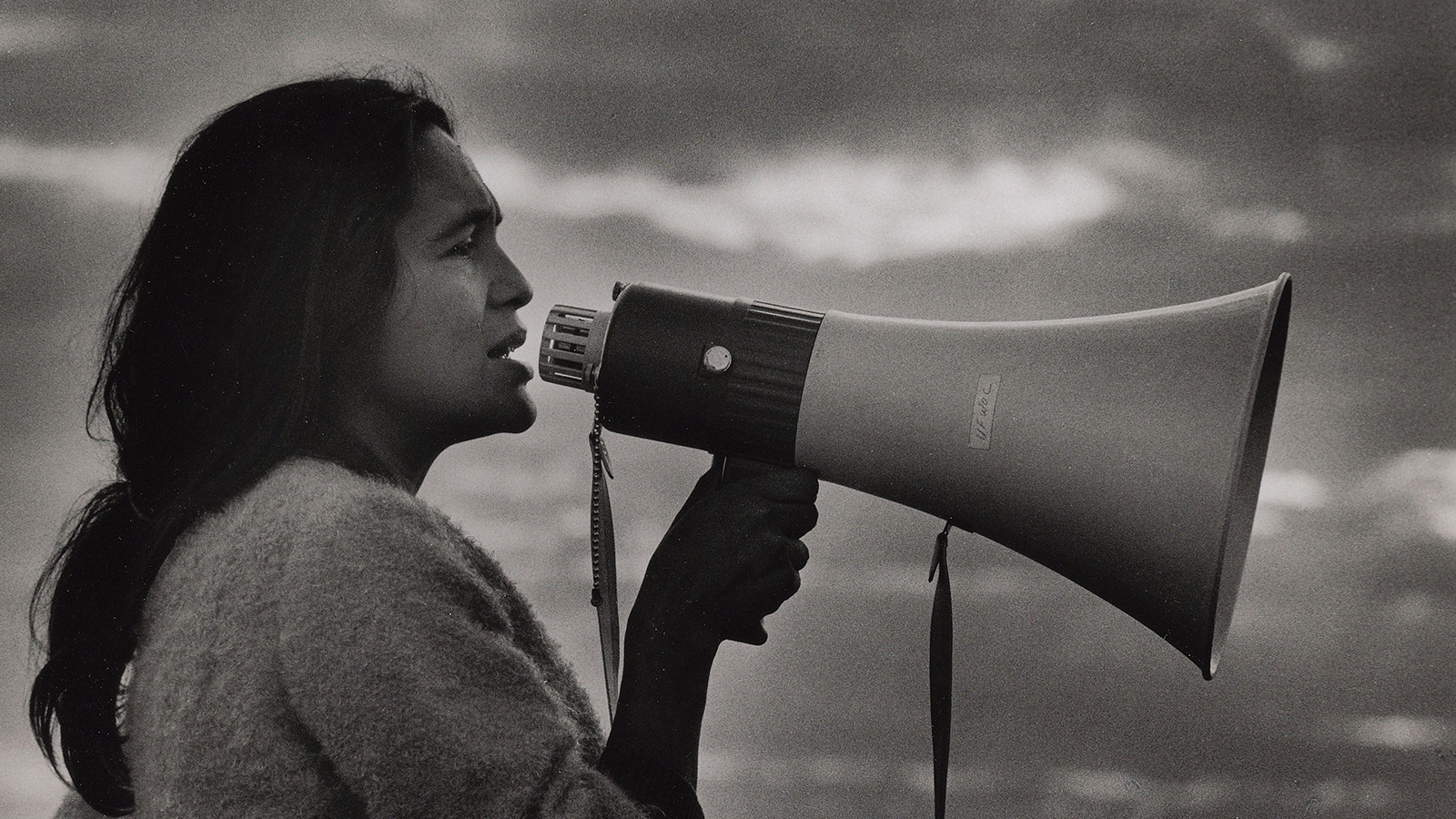 A young Dolores C. Huerta speaks into a bullhorn